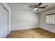 Bedroom features wood floors, ceiling fan and sliding closet doors at 9966 Mystic Moss St, Las Vegas, NV 89183