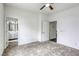 A bright bedroom boasts neutral walls, carpet, and access to the bathroom at 9966 Mystic Moss St, Las Vegas, NV 89183