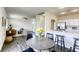 Open-concept dining area connecting to kitchen and living room featuring modern furniture and natural light at 9966 Mystic Moss St, Las Vegas, NV 89183