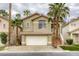 Charming two-story home featuring a two-car garage, terra cotta roof, and elegant stairwell entrance at 9966 Mystic Moss St, Las Vegas, NV 89183