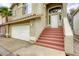 Inviting home with a two-car garage, front stairs, and well-maintained landscaping at 9966 Mystic Moss St, Las Vegas, NV 89183
