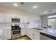 Modern kitchen featuring white cabinets, stainless steel appliances, and quartz countertops at 9966 Mystic Moss St, Las Vegas, NV 89183