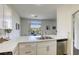 Bright kitchen features an island, stainless steel appliances, and views of the backyard at 9966 Mystic Moss St, Las Vegas, NV 89183
