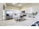 Modern kitchen featuring white cabinets, stainless steel appliances, quartz countertops and lots of natural light at 9966 Mystic Moss St, Las Vegas, NV 89183