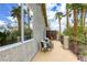 Private balcony with comfortable seating and scenic views of palm trees at 9966 Mystic Moss St, Las Vegas, NV 89183