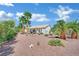 Beautiful backyard with lush palm trees, desert landscaping, and comfortable seating areas for relaxation at 10001 Cresent Creek Dr, Las Vegas, NV 89134