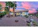 Inviting backyard with desert landscaping, a turtle sculpture, and a patio seating area for outdoor enjoyment at 10001 Cresent Creek Dr, Las Vegas, NV 89134