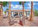 Inviting backyard patio with comfortable seating, fire pit, and lush landscaping, perfect for outdoor relaxation at 10001 Cresent Creek Dr, Las Vegas, NV 89134