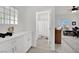 Bright hallway featuring a bathroom, cabinets with marble countertops, and an office at 10001 Cresent Creek Dr, Las Vegas, NV 89134