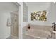 Modern bathroom with a soaking tub, glass-enclosed shower, and elegant finishes at 10001 Cresent Creek Dr, Las Vegas, NV 89134