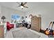 Bright bedroom with neutral walls, ceiling fan, and a large window with shutters at 10001 Cresent Creek Dr, Las Vegas, NV 89134