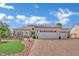 Beautiful single-story home featuring a tile roof, three-car garage, and inviting landscaping under a sunny sky at 10001 Cresent Creek Dr, Las Vegas, NV 89134