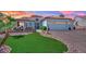 Lovely single-story home with a three-car garage, lush landscaping, and a cozy front patio at 10001 Cresent Creek Dr, Las Vegas, NV 89134