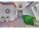 Welcoming front entrance with decorative plants and a charming walkway leading to the front door at 10001 Cresent Creek Dr, Las Vegas, NV 89134