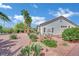 Inviting front yard with desert landscaping, including mature trees and cacti, offering a serene outdoor space at 10001 Cresent Creek Dr, Las Vegas, NV 89134