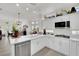 Bright open kitchen with modern appliances, white cabinetry, and an island with counter seating at 10001 Cresent Creek Dr, Las Vegas, NV 89134