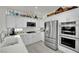 Bright kitchen features white cabinets, stainless steel appliances, and lots of counter space at 10001 Cresent Creek Dr, Las Vegas, NV 89134