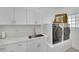 Laundry room features washer, dryer, sink, counter space, and cabinet storage at 10001 Cresent Creek Dr, Las Vegas, NV 89134