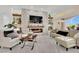 Inviting living room featuring a stone fireplace, floating shelves, and stylish furniture at 10001 Cresent Creek Dr, Las Vegas, NV 89134