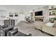 Elegant living room with a stone fireplace, modern decor, and a seamless flow into other living areas at 10001 Cresent Creek Dr, Las Vegas, NV 89134