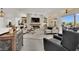 Open-concept living room featuring stone fireplace, contemporary furniture, and access to outdoor patio at 10001 Cresent Creek Dr, Las Vegas, NV 89134