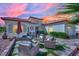 Inviting outdoor seating area featuring comfortable chairs and a decorative patio under a pink hued sky at 10001 Cresent Creek Dr, Las Vegas, NV 89134