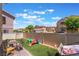 Fenced backyard showing a grass area with brick trim and neighborhood views at 1041 Grand Cerritos Ave, Las Vegas, NV 89183