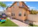 Cozy backyard featuring artificial grass, brick trim, and play area at 1041 Grand Cerritos Ave, Las Vegas, NV 89183
