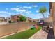 Exterior shot of a fenced backyard with artificial grass and a playground at 1041 Grand Cerritos Ave, Las Vegas, NV 89183
