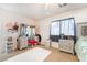 Comfortable bedroom with carpet flooring, window, and furniture at 1041 Grand Cerritos Ave, Las Vegas, NV 89183