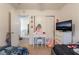 Bright bedroom features a vanity, closet, and television with dresser at 1041 Grand Cerritos Ave, Las Vegas, NV 89183
