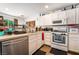 Cozy kitchen with white cabinets, stainless steel dishwasher, and breakfast bar at 1041 Grand Cerritos Ave, Las Vegas, NV 89183