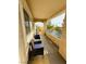 Inviting covered balcony featuring comfortable seating, offering a relaxing outdoor space with beautiful landscape view at 10553 Pine Glen Ave # 202, Las Vegas, NV 89144