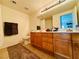 Bathroom with double sinks, wood cabinets, and a large mirror at 10553 Pine Glen Ave # 202, Las Vegas, NV 89144