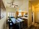 Inviting dining area with modern table, view to the kitchen, and a ceiling fan at 10553 Pine Glen Ave # 202, Las Vegas, NV 89144