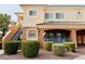 Well-maintained two-story condo building with lush landscaping, mature bushes, and convenient stairs to upper units at 10553 Pine Glen Ave # 202, Las Vegas, NV 89144