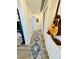 Hallway with wood flooring, a decorative rug, and a guitar hung for decoration at 10553 Pine Glen Ave # 202, Las Vegas, NV 89144