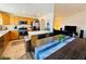 Open kitchen and dining area with wood cabinets, stainless steel appliances, and an island at 10553 Pine Glen Ave # 202, Las Vegas, NV 89144