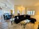 Open-concept living area flowing into the dining space, featuring stylish furniture, updated floors, and ample lighting at 10553 Pine Glen Ave # 202, Las Vegas, NV 89144