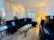 Comfortable living room with a plush couch, glass coffee table, and natural light from the window at 10553 Pine Glen Ave # 202, Las Vegas, NV 89144