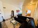 Cozy living room with a dark couch, area rug, and view into the dining and kitchen area at 10553 Pine Glen Ave # 202, Las Vegas, NV 89144