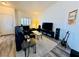 Bright living room featuring a sizable couch, glass coffee table, entertainment center and instrument at 10553 Pine Glen Ave # 202, Las Vegas, NV 89144