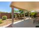 Charming backyard with covered patio and water fountain, perfect for relaxing and entertaining at 11073 Gateview Ln, Las Vegas, NV 89144