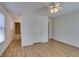 Bright bedroom features a modern ceiling fan and light wood-look laminate flooring, with bathroom view at 11073 Gateview Ln, Las Vegas, NV 89144
