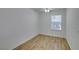 Bedroom with wood-look floors, a ceiling fan, and a bright window at 11073 Gateview Ln, Las Vegas, NV 89144
