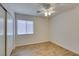 An empty bedroom is bathed in natural light and has wood flooring at 11073 Gateview Ln, Las Vegas, NV 89144