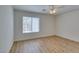 Bright bedroom features modern ceiling fan and light wood-look laminate flooring at 11073 Gateview Ln, Las Vegas, NV 89144