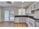 A well-equipped kitchen features granite countertops and a sliding door to the patio at 11073 Gateview Ln, Las Vegas, NV 89144