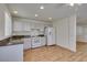An open kitchen features white appliances, granite countertops, and wood flooring at 11073 Gateview Ln, Las Vegas, NV 89144