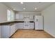 Bright kitchen featuring white appliances, granite countertops, and wood flooring at 11073 Gateview Ln, Las Vegas, NV 89144